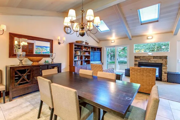 a view of a dining room with furniture a chandelier and wooden floor