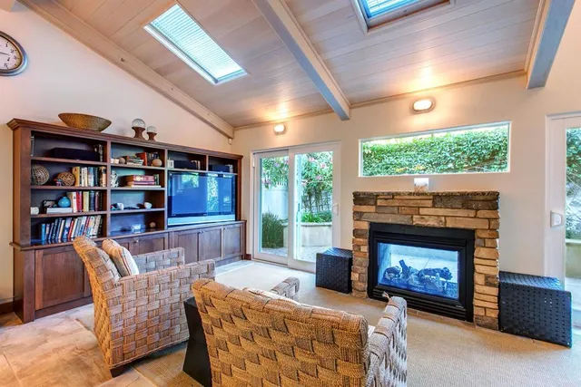 a living room with furniture a fireplace and a bookshelf