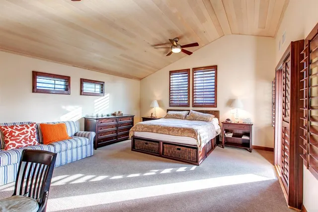 a spacious bedroom with a bed and a couch