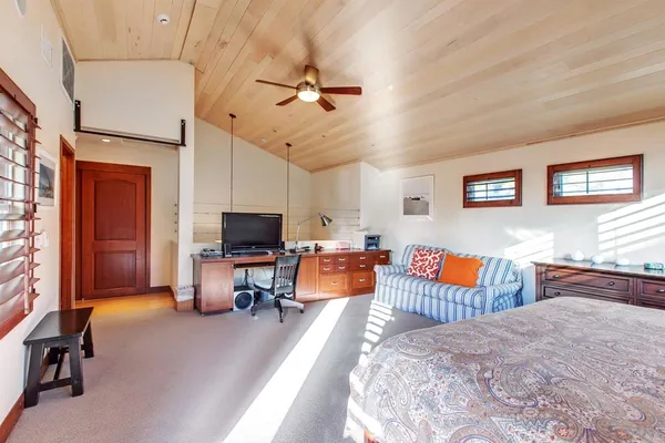 a bedroom with furniture and a flat screen tv
