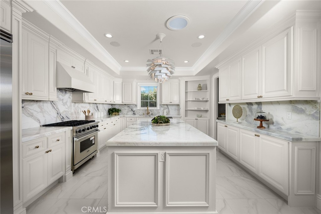407 Oxford Drive Arcadia, CA 91007 - Photo 12 of 29 a kitchen with kitchen island granite countertop a sink a stove a refrigerator and white cabinets