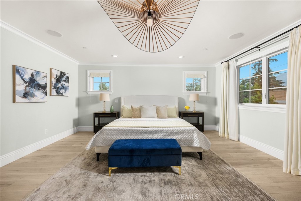 407 Oxford Drive Arcadia, CA 91007 - Photo 20 of 29 a spacious bedroom with a large bed a chandelier and windows
