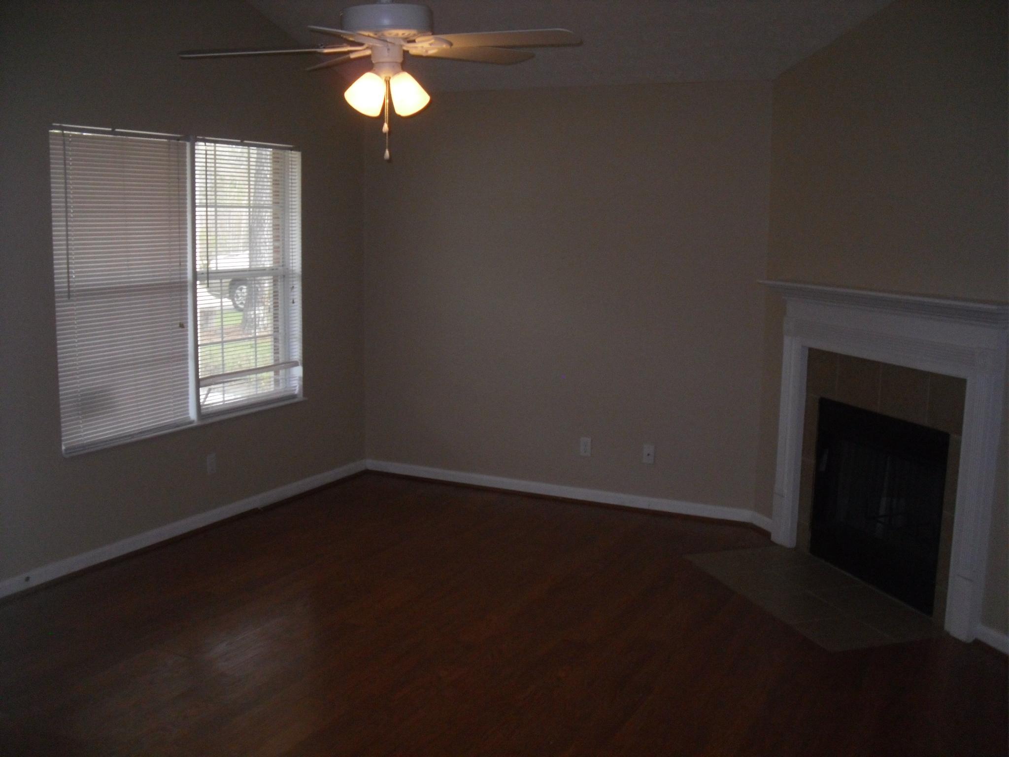 355 Bay Grove Road Freeport, FL 32439 - Photo 5 of 12 a view of an empty room with wooden floor and a window