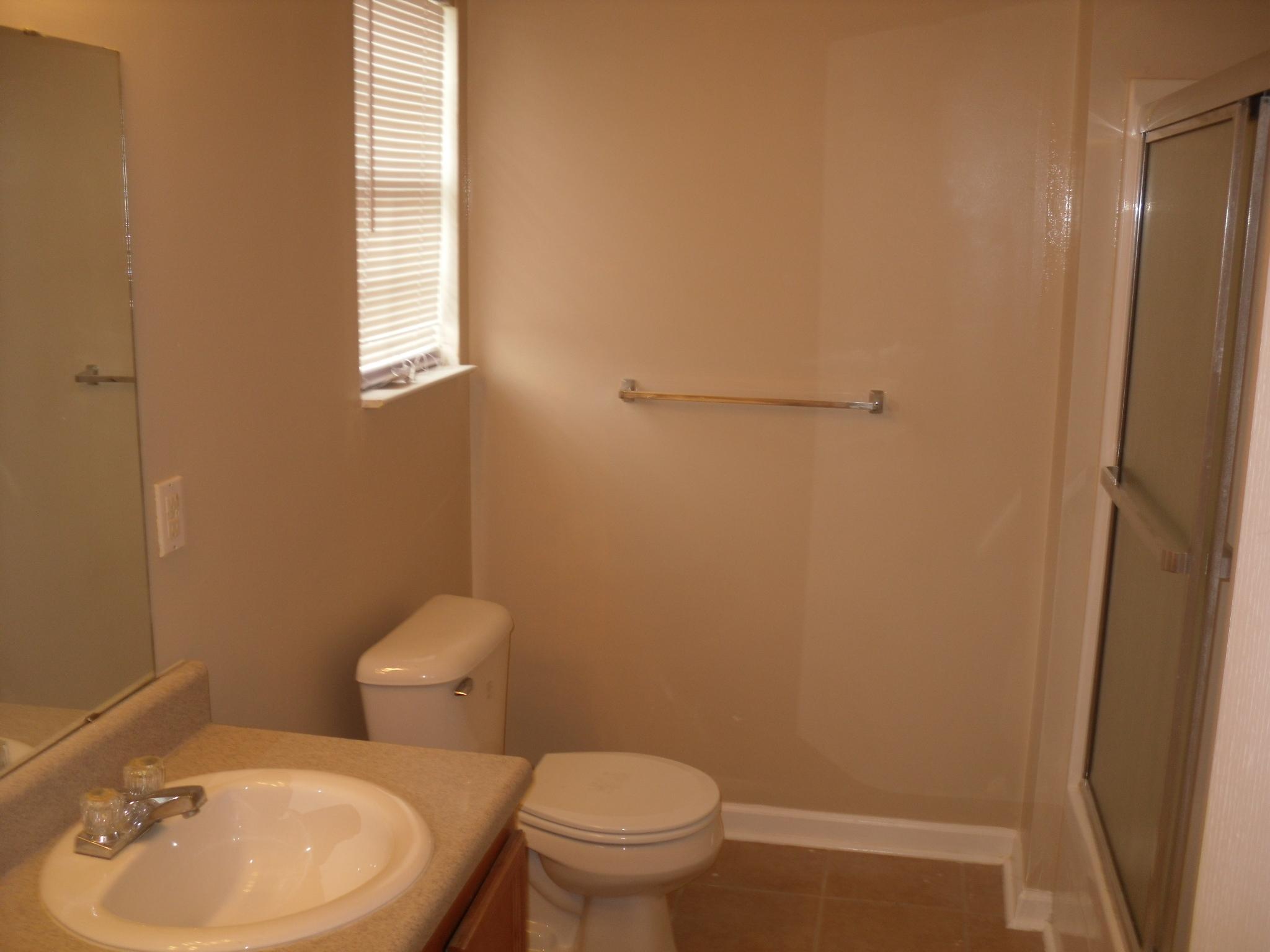 355 Bay Grove Road Freeport, FL 32439 - Photo 7 of 12 a white toilet sitting next to a bathroom sink