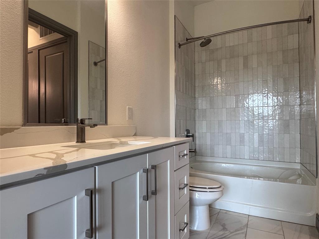 2700 Old Denton Road, Unit 1030 Carrollton, TX 75007 - Photo 11 of 28 a bathroom with a granite countertop sink toilet and shower