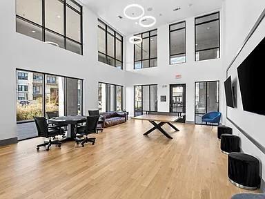 2700 Old Denton Road, Unit 1030 Carrollton, TX 75007 - Photo 20 of 28 a living room filled with furniture hardwood floor and a flat screen tv