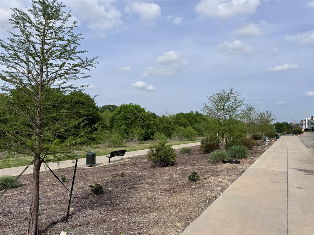 2700 Old Denton Road, Unit 1030 Carrollton, TX 75007 - Photo 25 of 28 a view of a pathway with a wrought fence