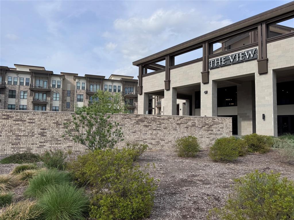 2700 Old Denton Road, Unit 1030 Carrollton, TX 75007 - Photo 27 of 28 a front view of a house with garden