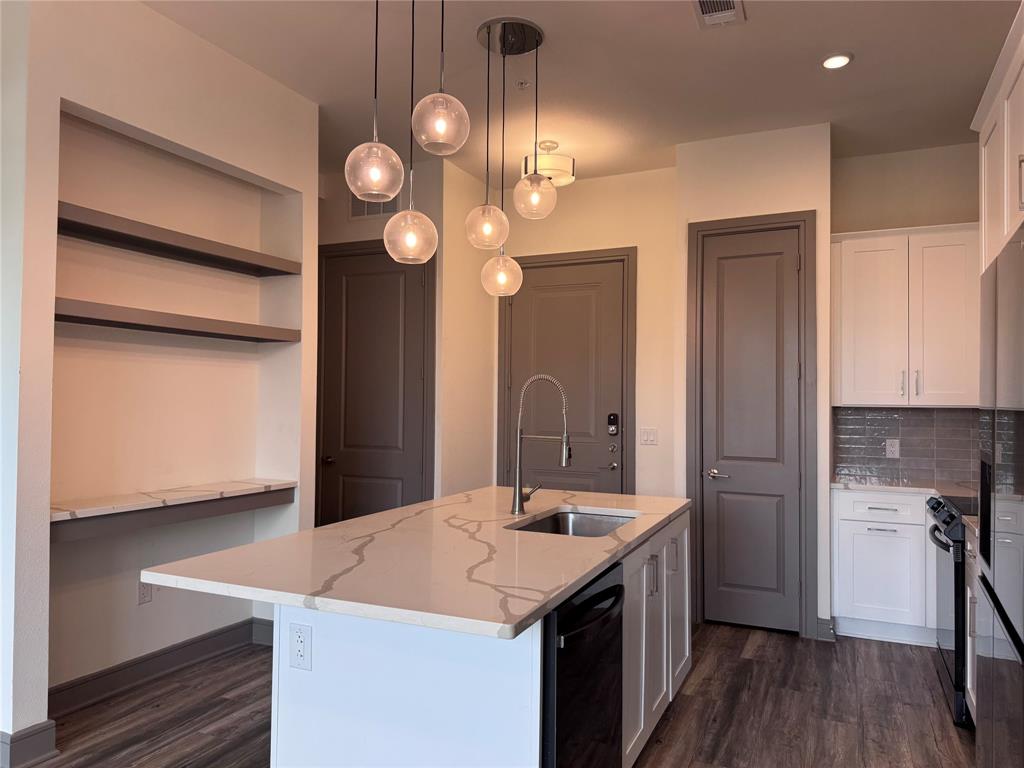 2700 Old Denton Road, Unit 1030 Carrollton, TX 75007 - Photo 5 of 28 a kitchen with a sink and a refrigerator