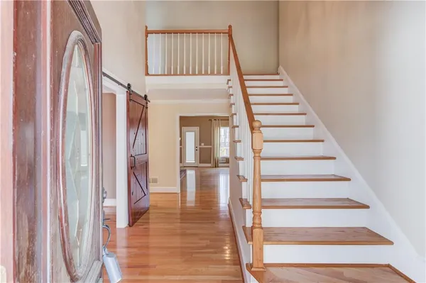 a view of entryway and hall with wooden floor