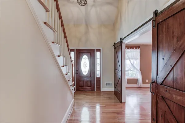 a view of wooden floor chandelier and window in a room