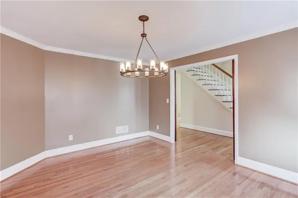 a view of an empty room with a fireplace and a window