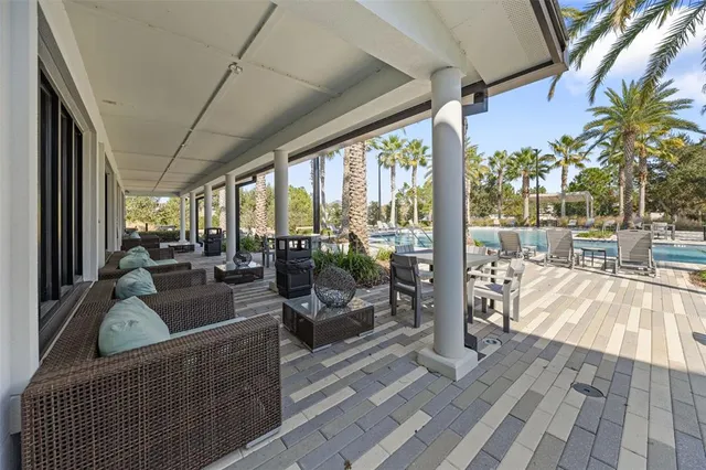 a view of a patio with table and chairs potted plants with wooden floor and fence