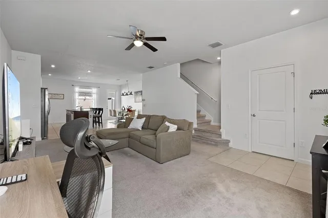 a view of a workspace with furniture and a window