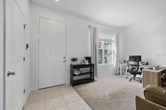 a living room with furniture and a ceiling fan