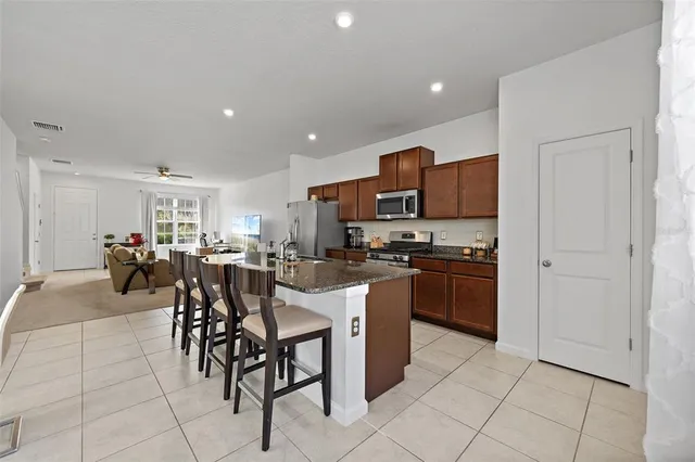a kitchen with granite countertop a sink and cabinets