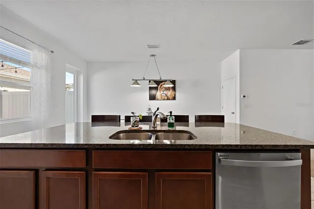 a kitchen with stainless steel appliances granite countertop a sink stove and microwave