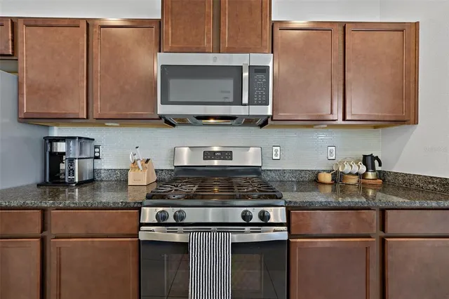 a large kitchen with a counter space a sink and appliances