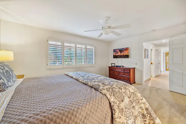 a bathroom with a granite countertop sink a toilet and shower