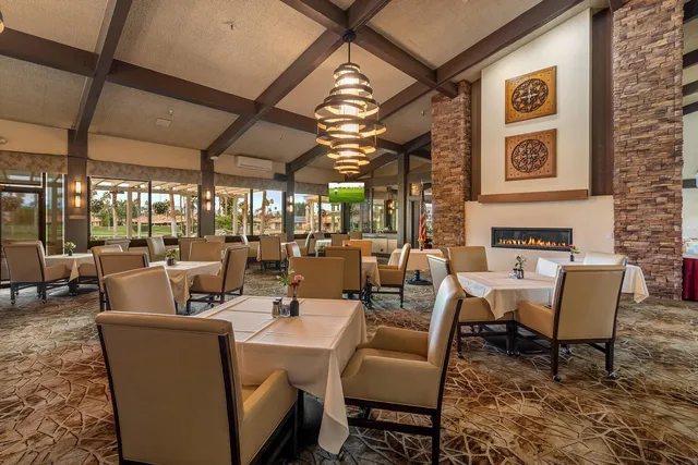 a view of a chairs and table in patio with a yard