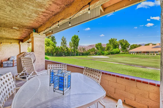a view of swimming pool with outdoor seating and yard
