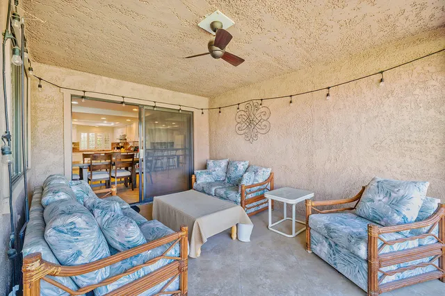 a living room with furniture a rug and a chandelier