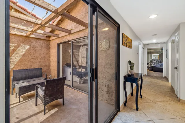 a view of a hallway with furniture and front door