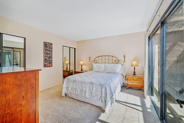 a bedroom with a bed and a lamp with window