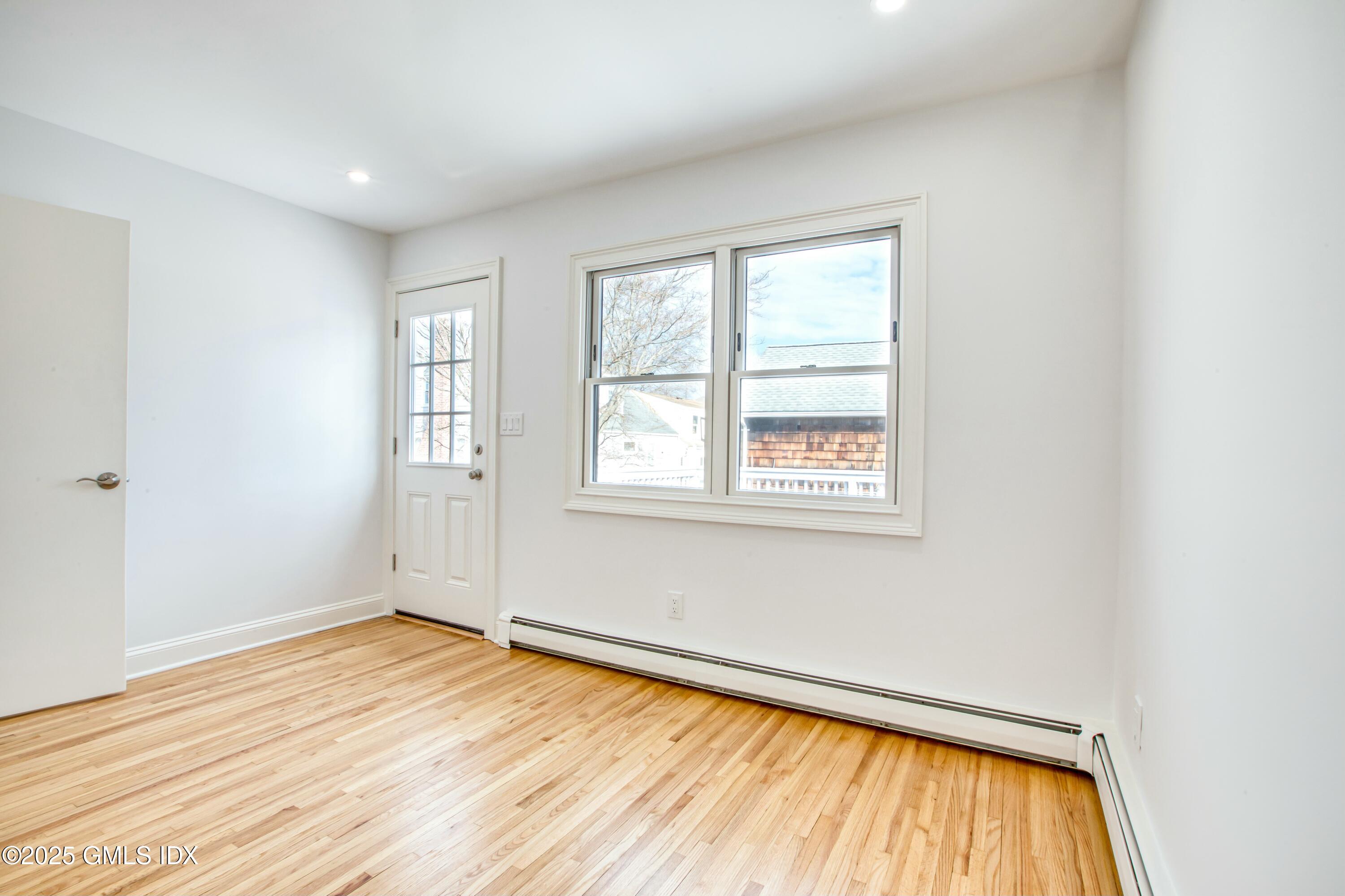 9 Apache Place Riverside, CT 06878 - Photo 11 of 23 an empty room with wooden floor and windows