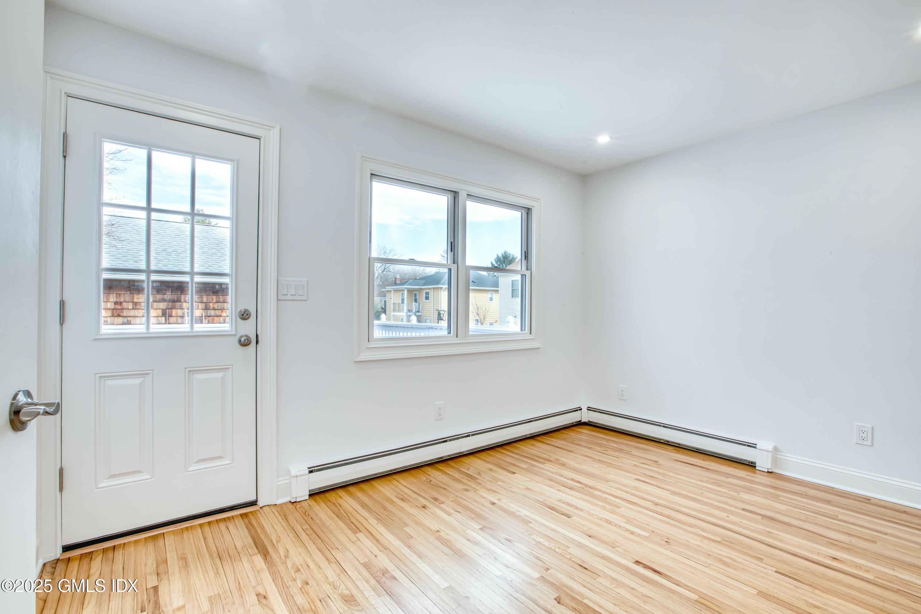 9 Apache Place Riverside, CT 06878 - Photo 12 of 23 an empty room with wooden floor and windows