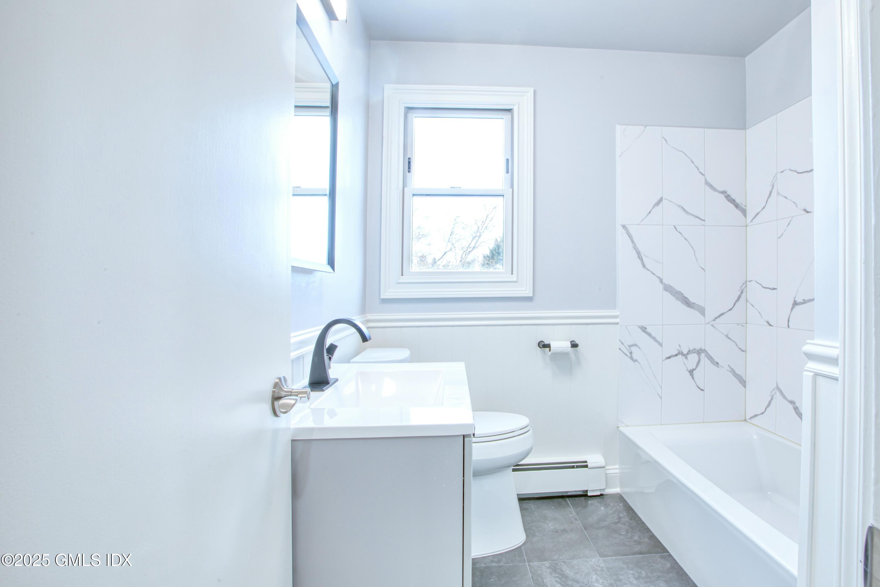 9 Apache Place Riverside, CT 06878 - Photo 14 of 23 a bathroom with a sink toilet and bathtub