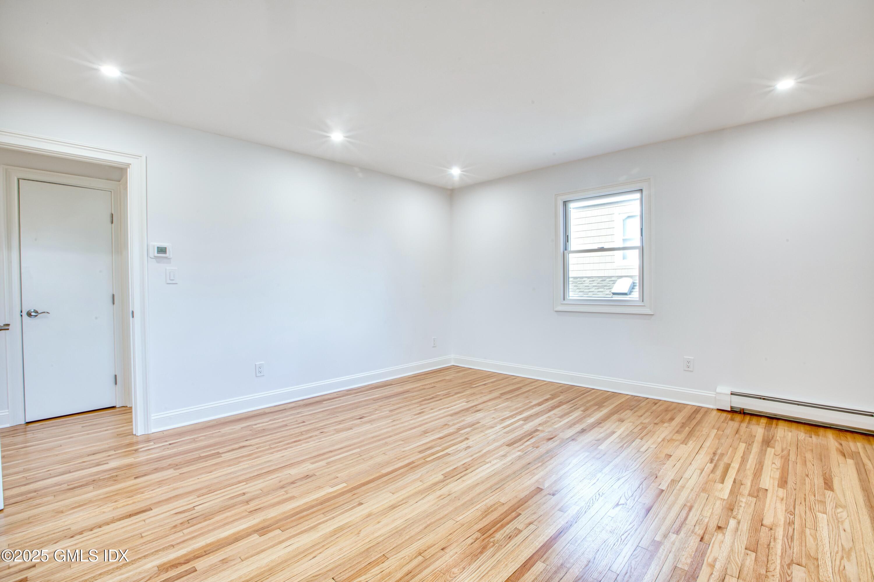 9 Apache Place Riverside, CT 06878 - Photo 17 of 23 an empty room with wooden floor and windows