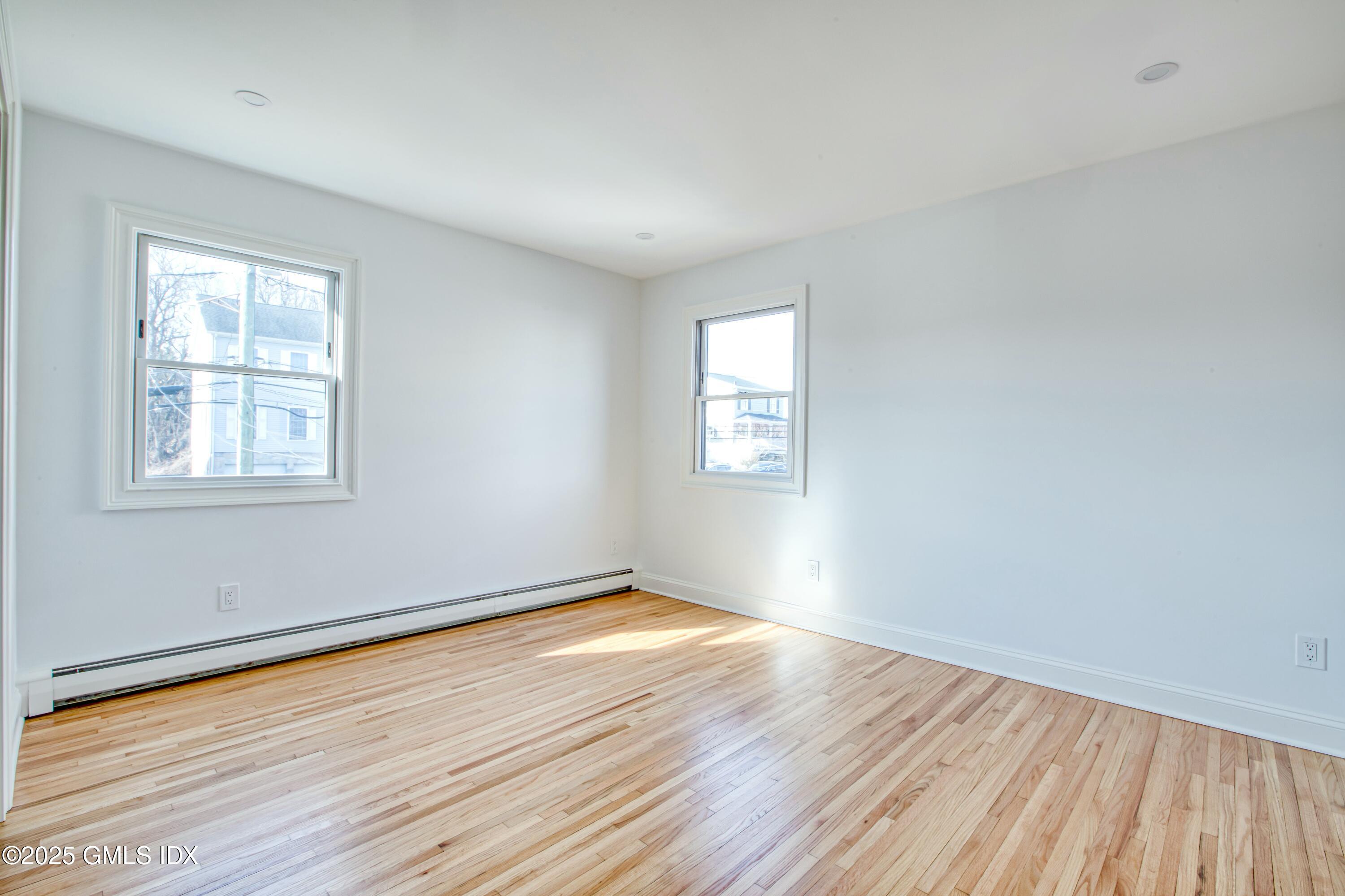 9 Apache Place Riverside, CT 06878 - Photo 20 of 23 a view of an empty room with wooden floor and a window