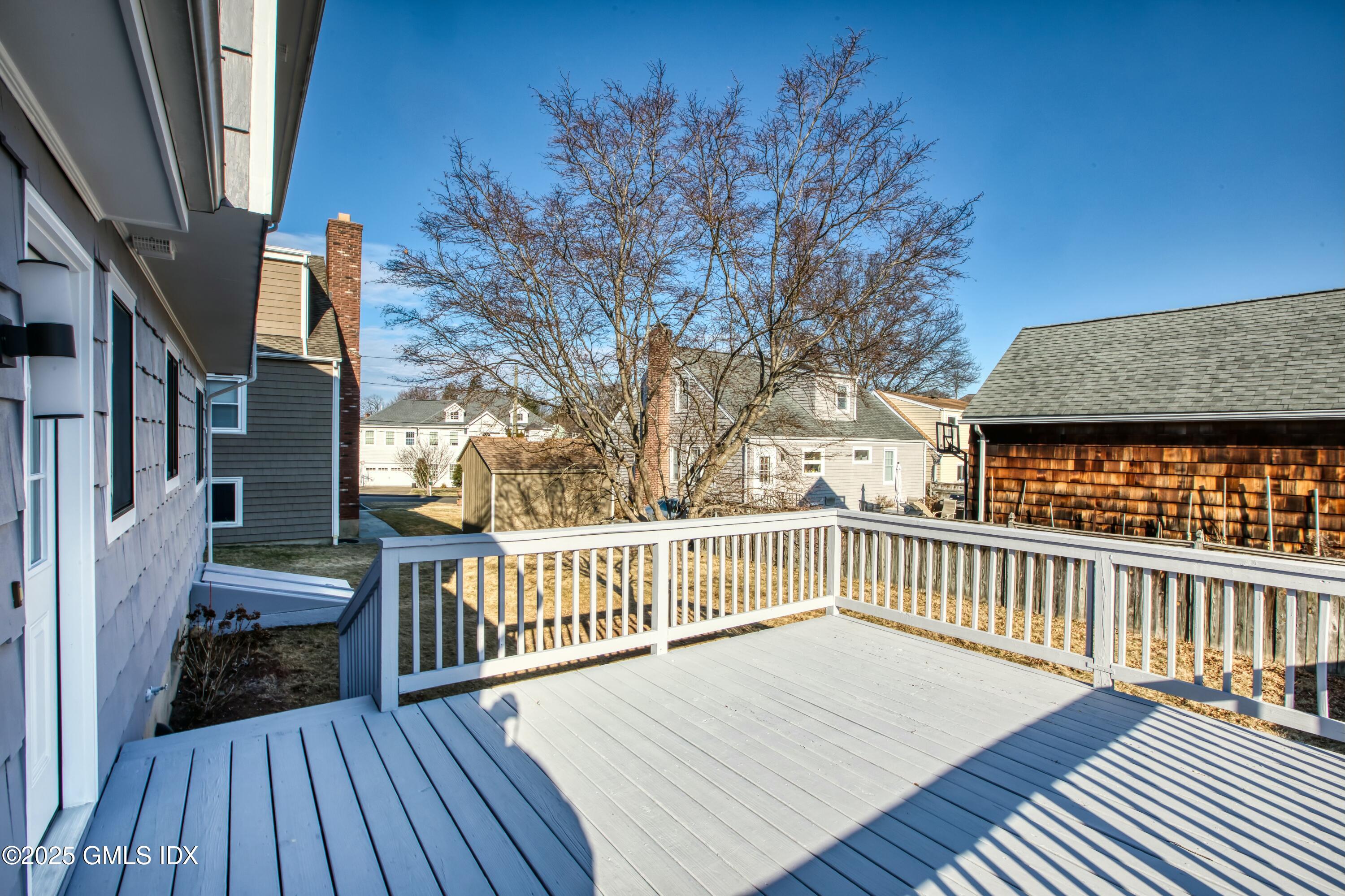 9 Apache Place Riverside, CT 06878 - Photo 3 of 23 a view of a deck with wooden floor and fence with a large window