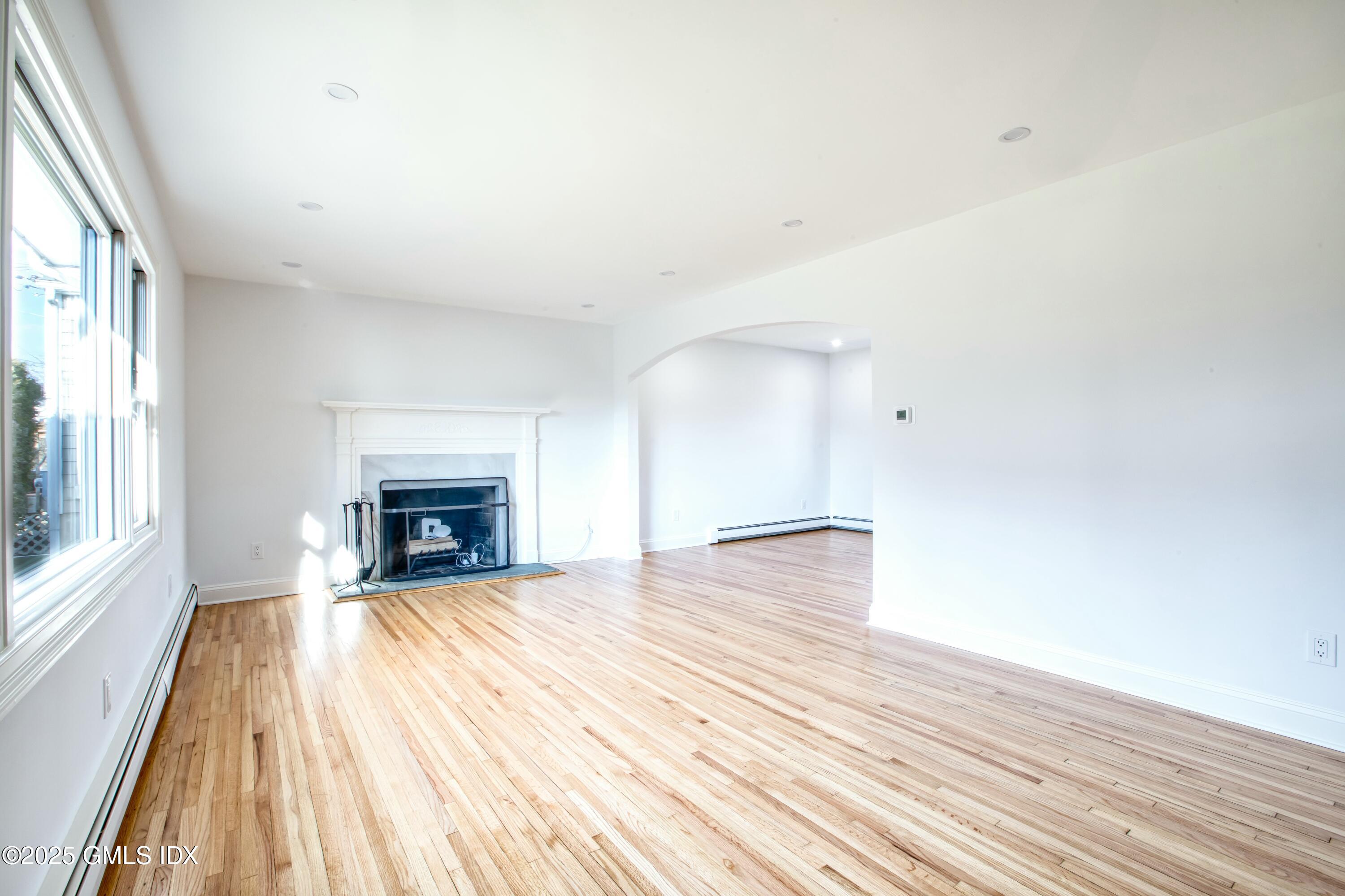 9 Apache Place Riverside, CT 06878 - Photo 4 of 23 a view of empty room with wooden floor and fireplace