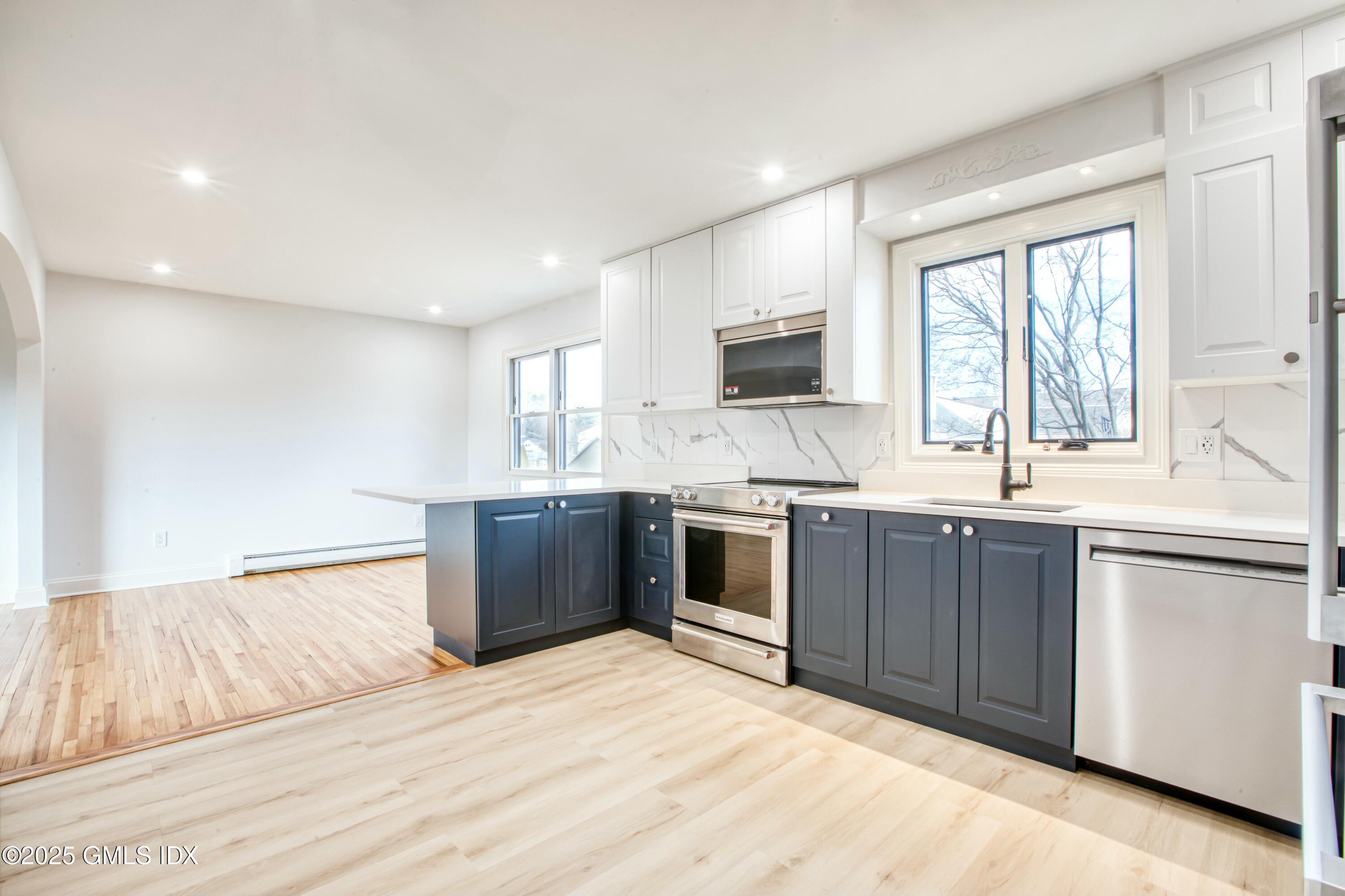9 Apache Place Riverside, CT 06878 - Photo 8 of 23 a kitchen with stainless steel appliances kitchen island granite countertop a sink and cabinets