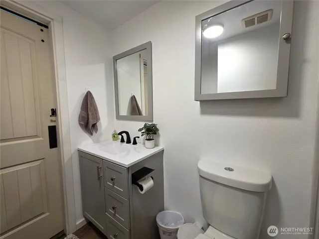 a bathroom with a toilet sink and mirror