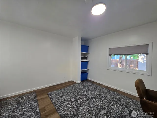 a view of room with window and wooden floor