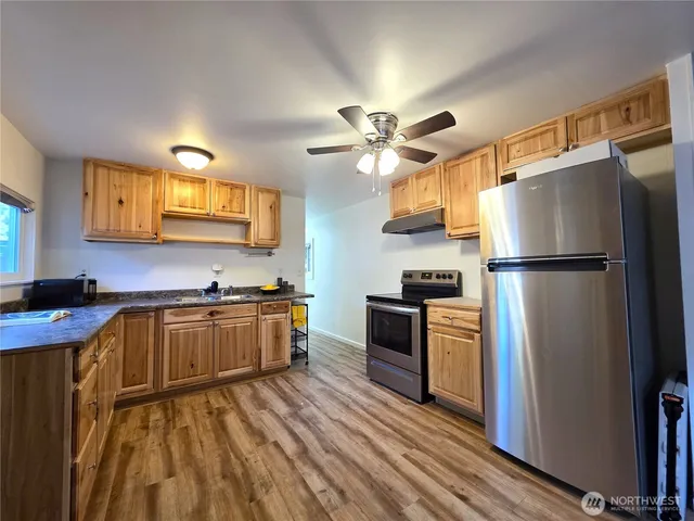 a kitchen with a refrigerator a stove top oven a sink and dishwasher