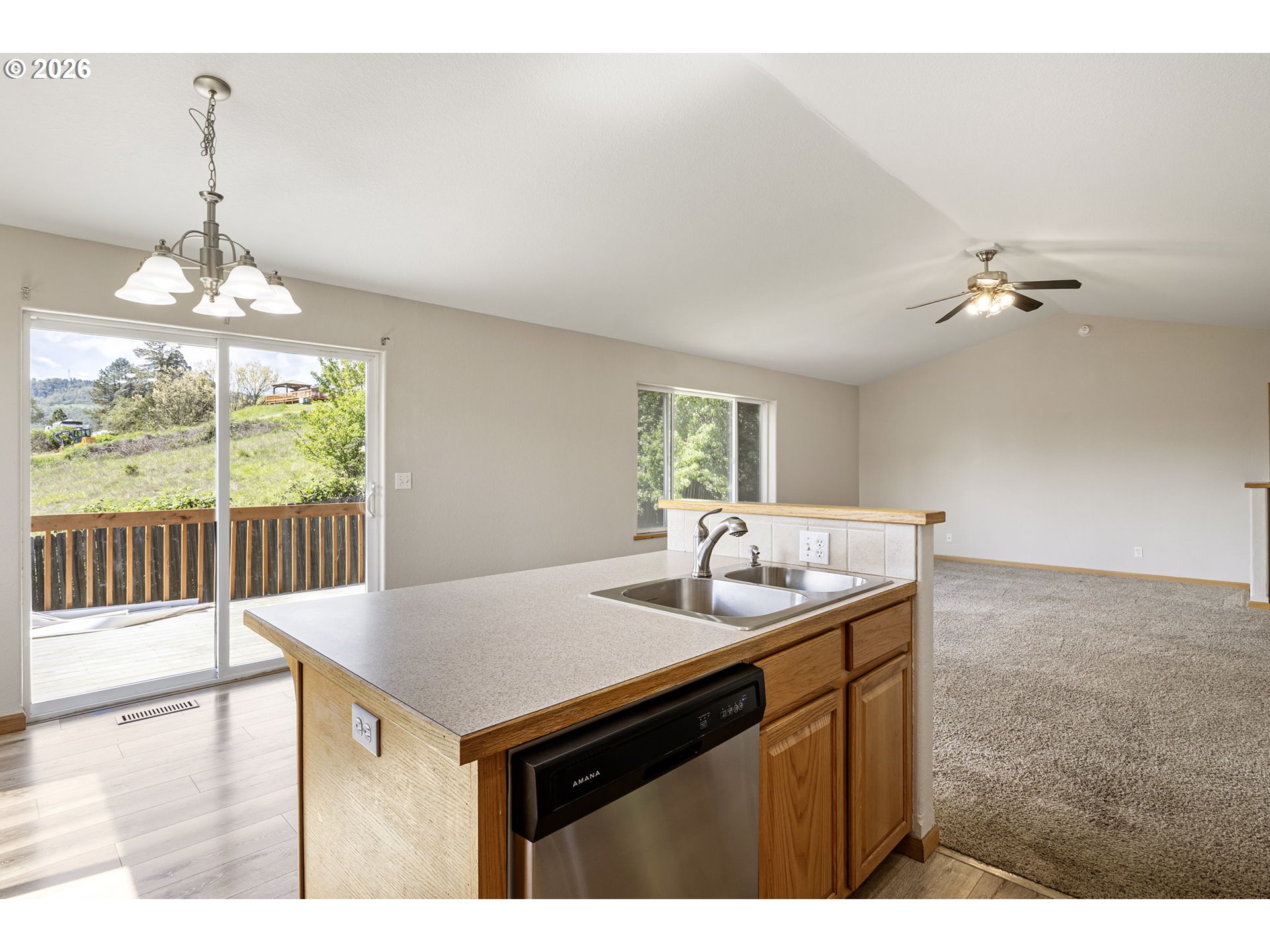 223 Armande Loop Roseburg, OR 97471 - Photo 11 of 35 a kitchen with a sink cabinets and wooden floor