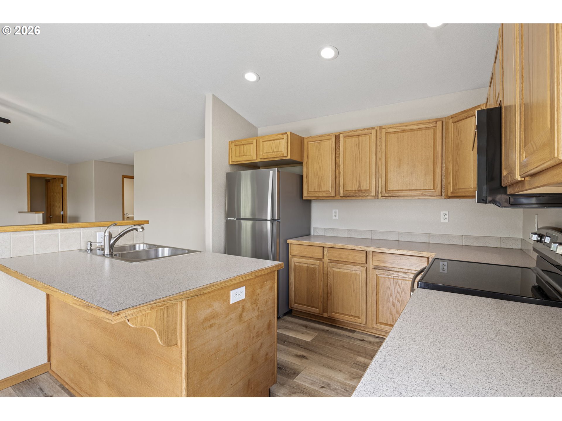 223 Armande Loop Roseburg, OR 97471 - Photo 12 of 35 a kitchen with stainless steel appliances granite countertop a sink refrigerator and cabinets