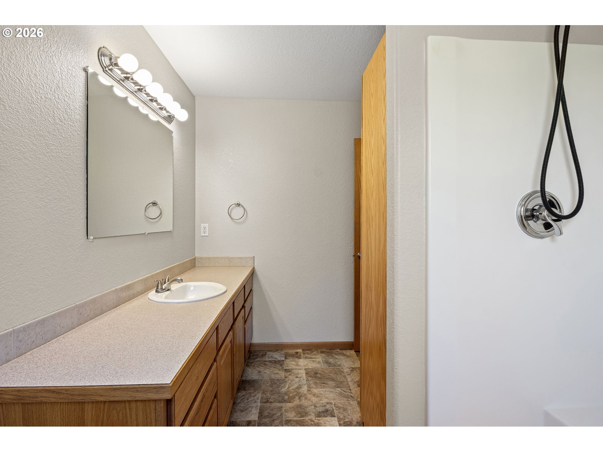 223 Armande Loop Roseburg, OR 97471 - Photo 19 of 35 a bathroom with a sink a mirror and a shower