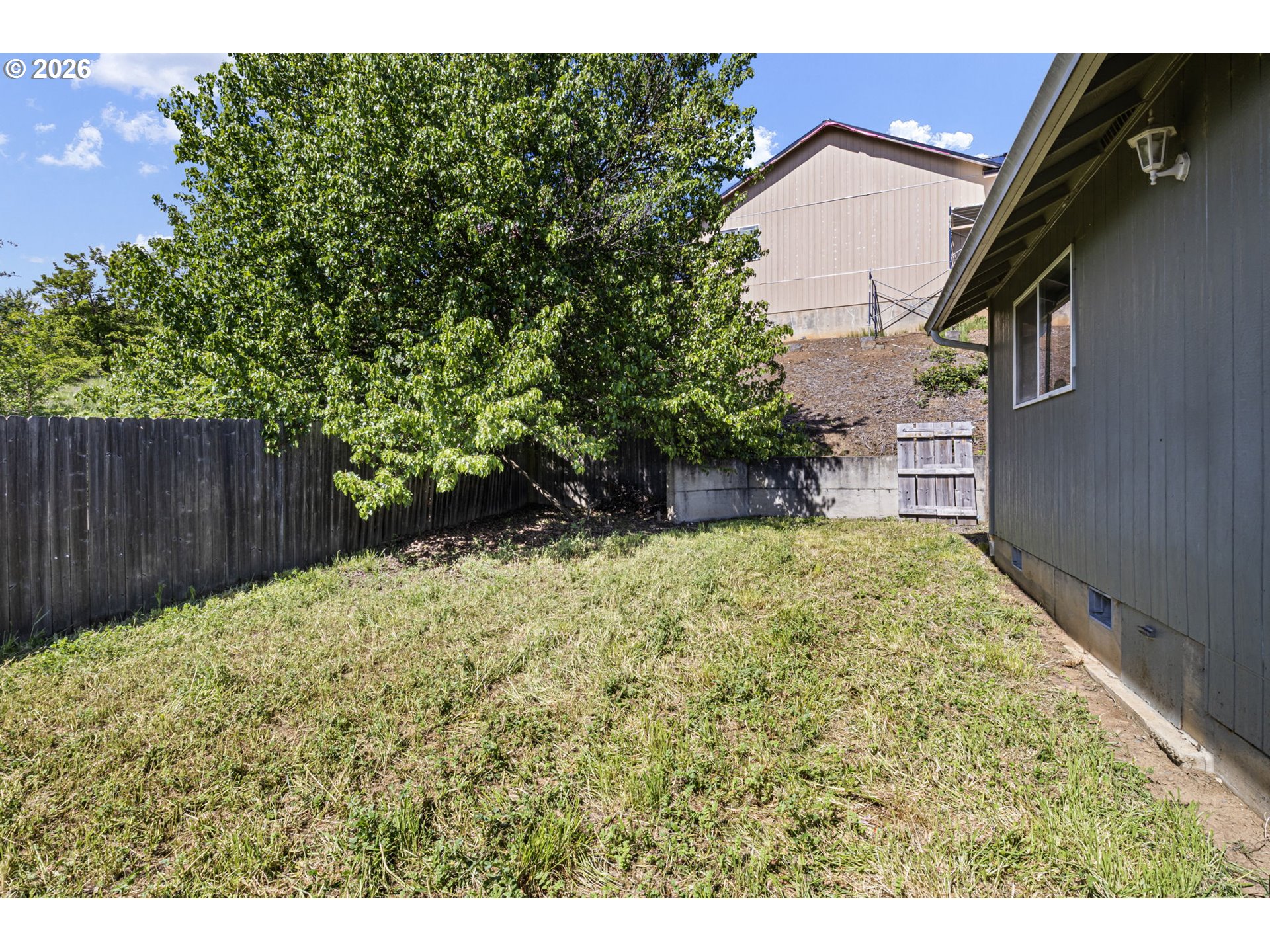 223 Armande Loop Roseburg, OR 97471 - Photo 32 of 35 a view of a yard with plants and wooden fence