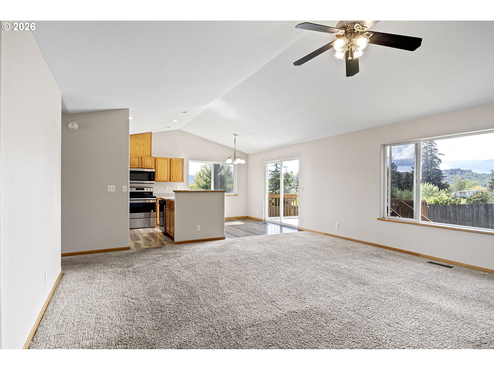 223 Armande Loop Roseburg, OR 97471 - Photo 4 of 35 a view of a kitchen with furniture a ceiling fan and window