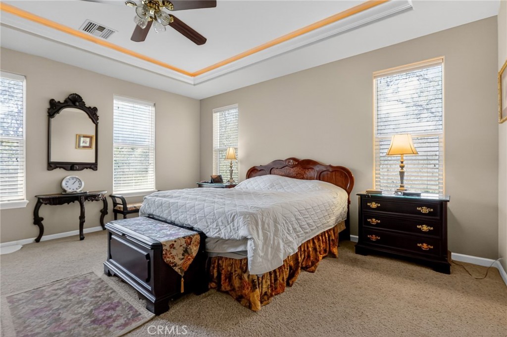 19370 Park Ridge Drive Hidden Valley Lake, CA 95467 - Photo 16 of 61 a spacious bedroom with a bed a chandelier and a dresser
