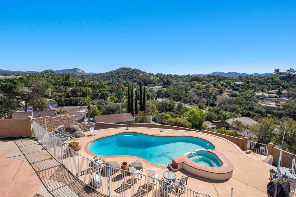2016 South Grade Road Alpine, CA 91901 - Photo 4 of 27 a view of a swimming pool and trees in the background