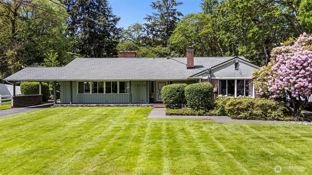 a front view of a house with yard and green space