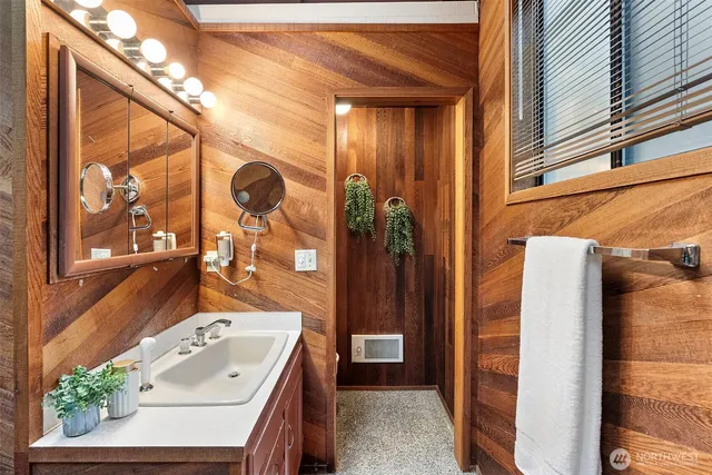 a bathroom with a sink a mirror and a shower