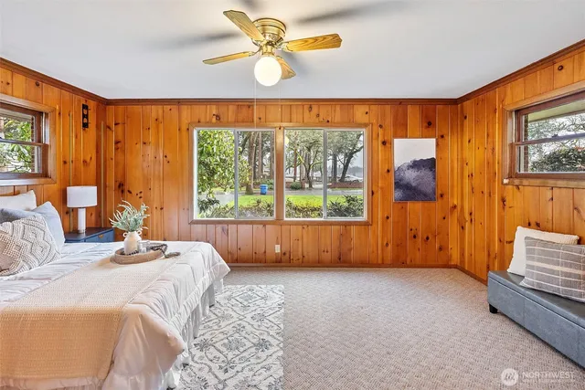 a bedroom with furniture and a large window