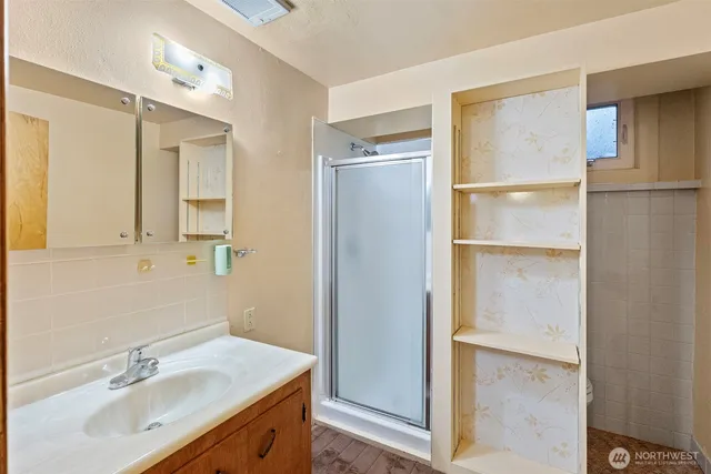 a bathroom with a sink vanity tub and a mirror